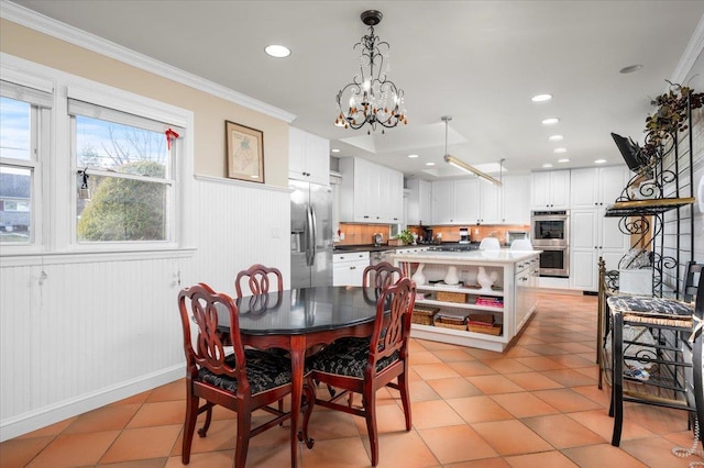 tiled dining room featuring ornamental molding and a chandelier