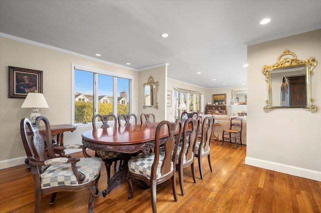 dining area featuring ornamental molding and light wood-type flooring