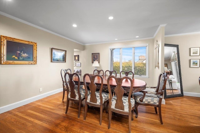 dining space with crown molding and wood-type flooring