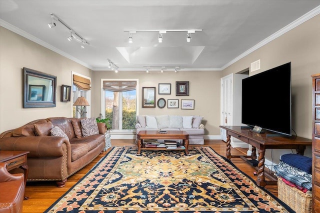 living room with ornamental molding and light hardwood / wood-style flooring