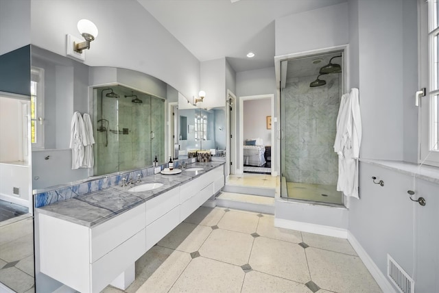 bathroom featuring walk in shower and vanity