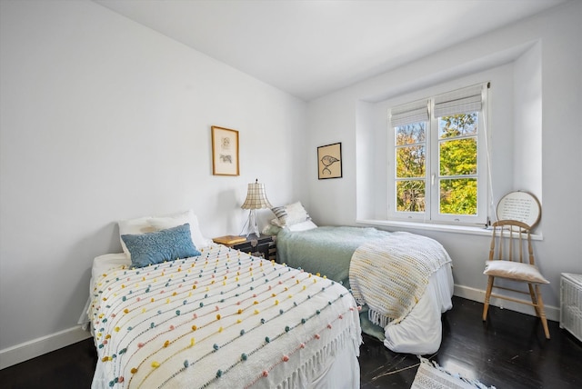 bedroom with dark hardwood / wood-style flooring