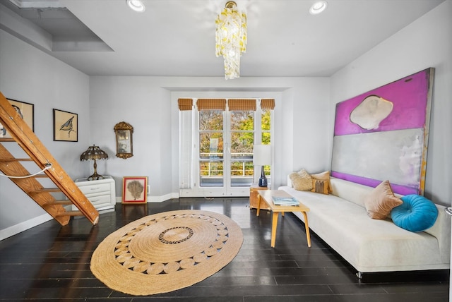 sitting room with dark hardwood / wood-style flooring and an inviting chandelier