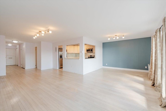 unfurnished living room with light wood-type flooring