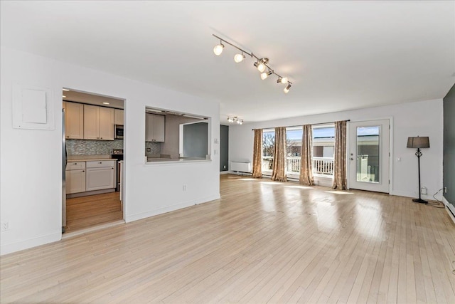 unfurnished living room with light wood-type flooring