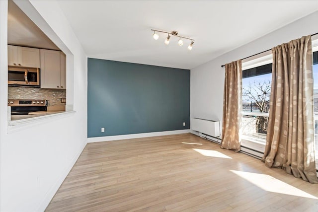 unfurnished dining area with light wood-type flooring