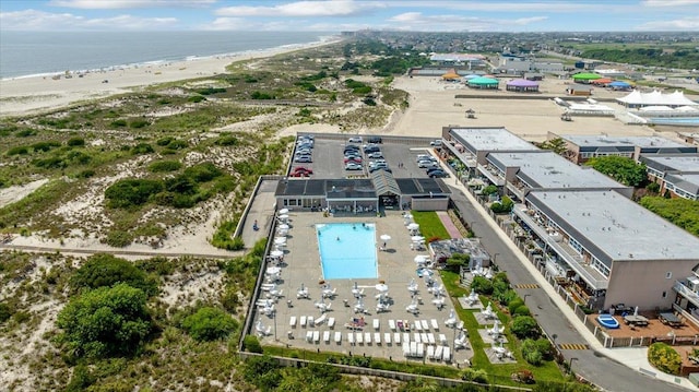 birds eye view of property featuring a view of the beach and a water view