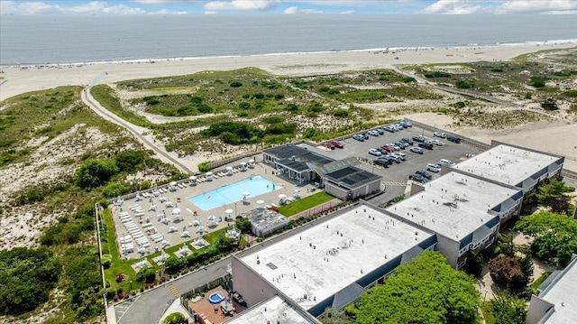 birds eye view of property featuring a view of the beach and a water view