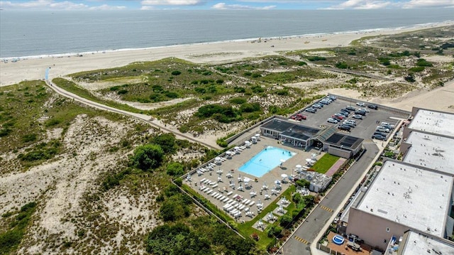 drone / aerial view featuring a water view and a view of the beach