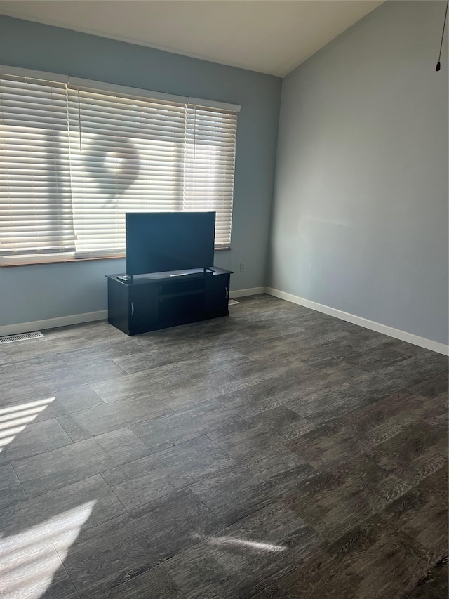 interior space with hardwood / wood-style flooring and lofted ceiling