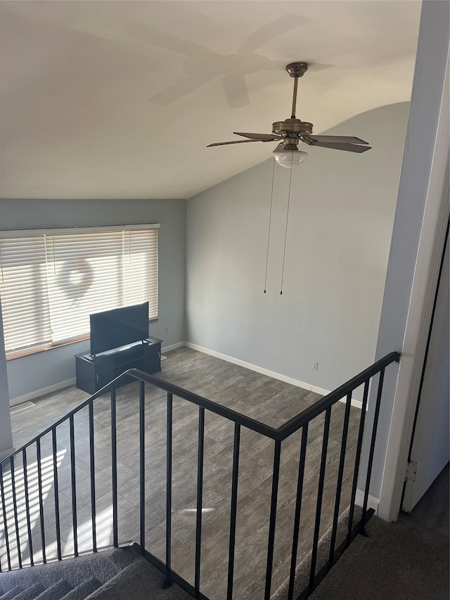 stairway featuring hardwood / wood-style flooring and lofted ceiling