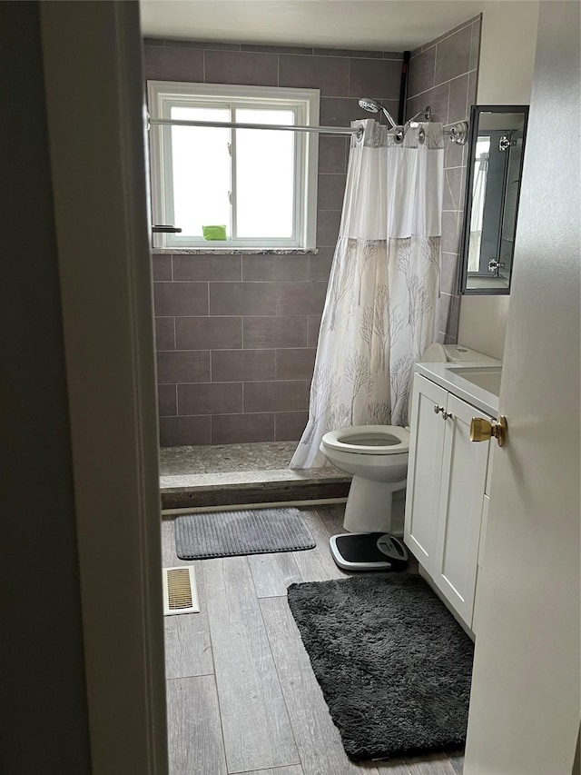 bathroom with vanity, hardwood / wood-style flooring, toilet, and a shower with shower curtain