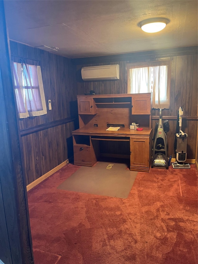 office featuring wooden walls, a wall mounted air conditioner, carpet flooring, and a wealth of natural light