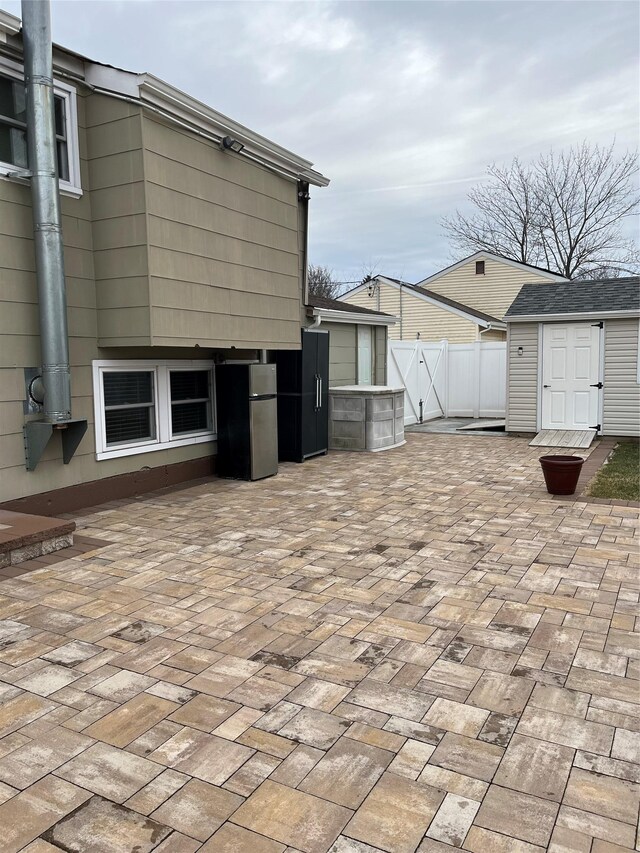 view of patio featuring a shed