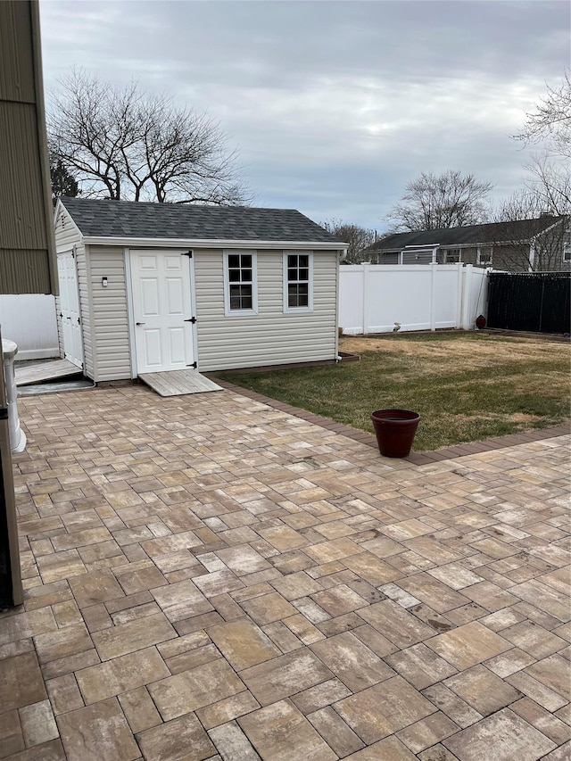 view of outbuilding featuring a lawn and a patio