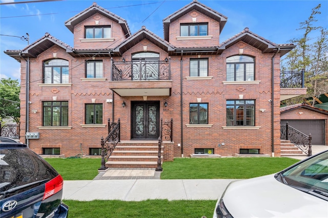 view of front of property with a garage, a front yard, and french doors