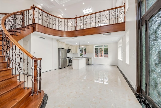 foyer entrance with a towering ceiling