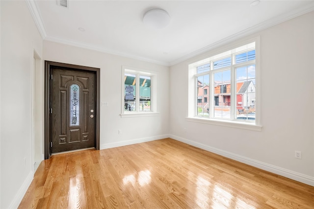 entryway with crown molding and light hardwood / wood-style flooring