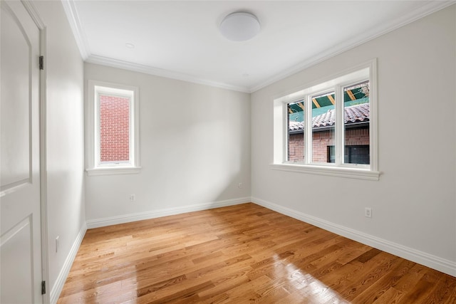 unfurnished room with ornamental molding and light hardwood / wood-style floors