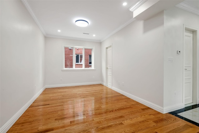 spare room with light hardwood / wood-style flooring and ornamental molding