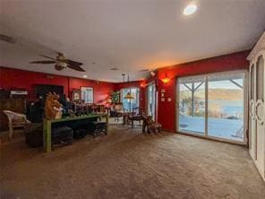 unfurnished living room with ceiling fan and carpet