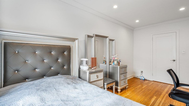 bedroom featuring crown molding and light hardwood / wood-style floors