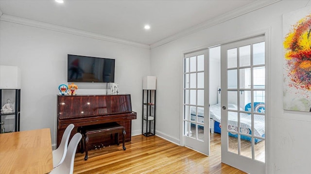 miscellaneous room with french doors, ornamental molding, and light hardwood / wood-style flooring