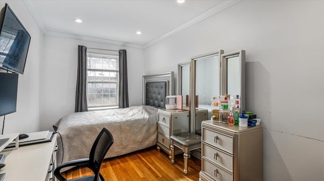 bedroom featuring hardwood / wood-style flooring and ornamental molding