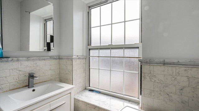 bathroom with tile walls and vanity