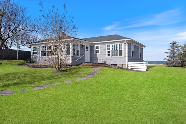 back of house featuring a lawn