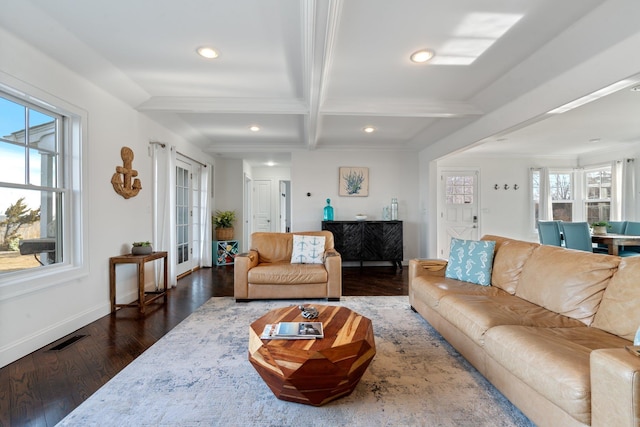 living room featuring coffered ceiling, a wealth of natural light, dark wood-type flooring, and beamed ceiling