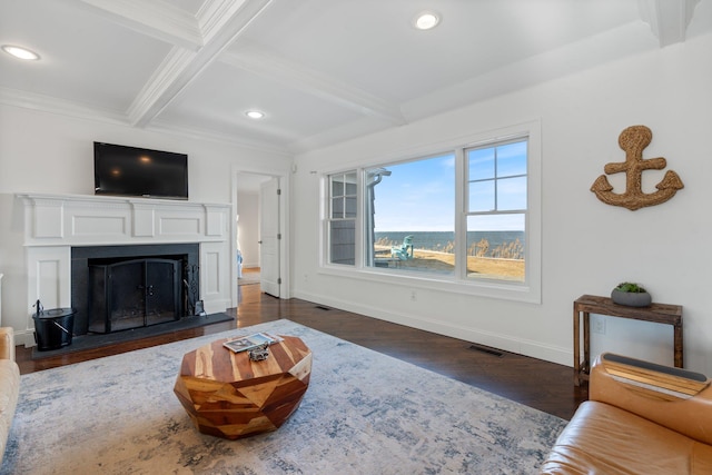 living room with beamed ceiling, ornamental molding, and dark wood-type flooring