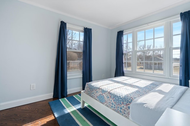 bedroom featuring dark wood-type flooring and crown molding