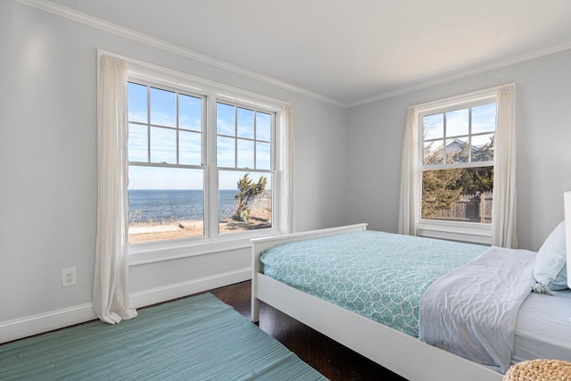 bedroom featuring crown molding, a water view, and wood-type flooring