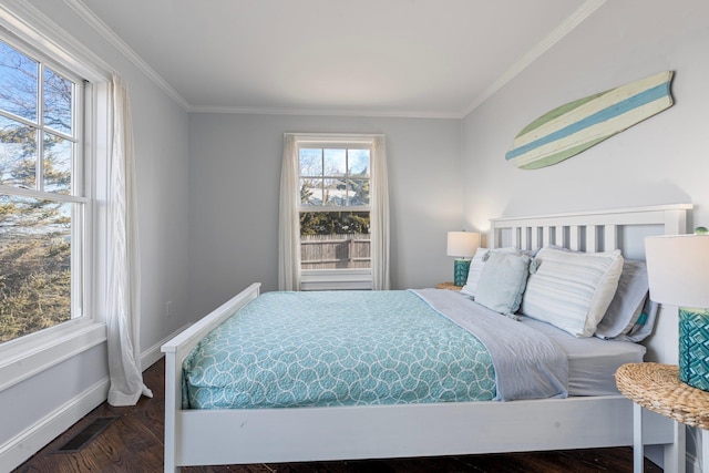 bedroom featuring crown molding and dark wood-type flooring