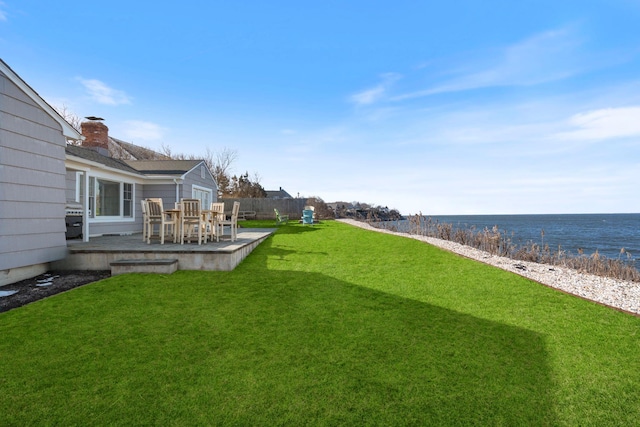 view of yard with a patio area and a water view