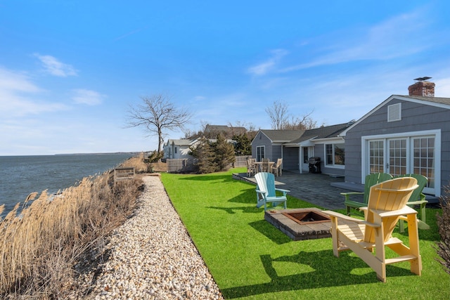 view of yard with a water view and a patio