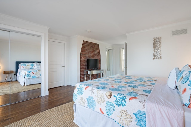 bedroom with dark wood-type flooring and crown molding