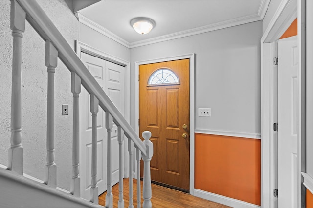 entryway featuring ornamental molding and wood-type flooring