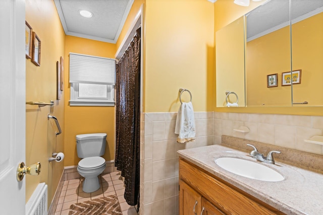 bathroom featuring tile patterned floors, toilet, a textured ceiling, tile walls, and vanity