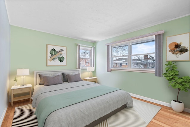 bedroom featuring light hardwood / wood-style flooring and a textured ceiling