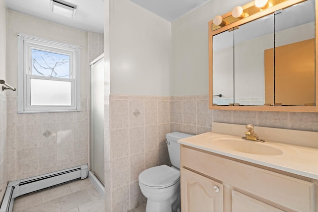 bathroom featuring baseboard heating, tile walls, vanity, toilet, and walk in shower