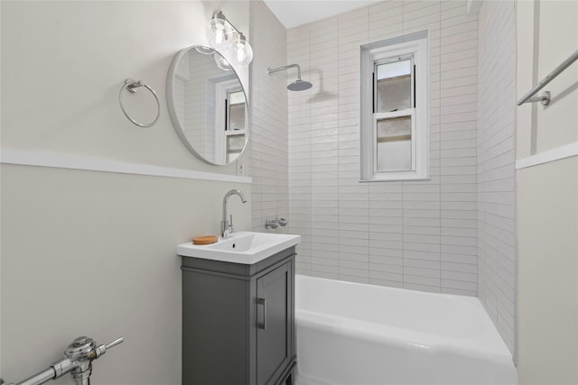 bathroom with vanity and tiled shower / bath combo