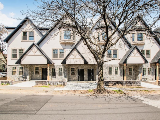 65 W 2nd St Unit 7, Mount Vernon, NY 10550 - view of front of home with stucco siding, a porch, and stone siding