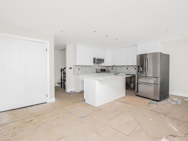 65 W 2nd St Unit 7, Mount Vernon, NY 10550 - kitchen with an island with sink, light countertops, white cabinetry, appliances with stainless steel finishes, and backsplash