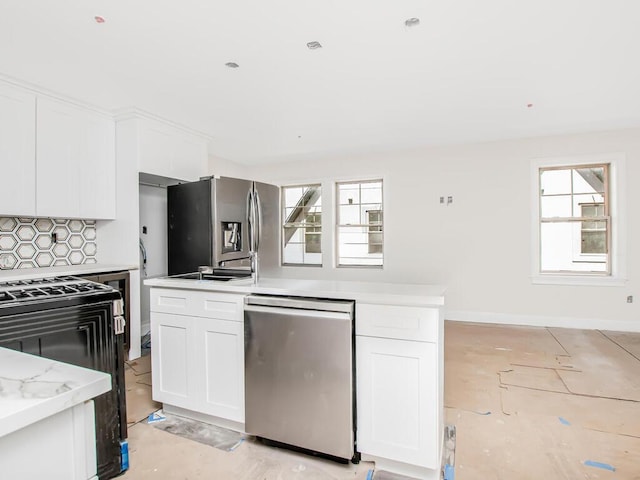 65 W 2nd St Unit 7, Mount Vernon, NY 10550 - kitchen with backsplash, stainless steel appliances, baseboards, and white cabinetry