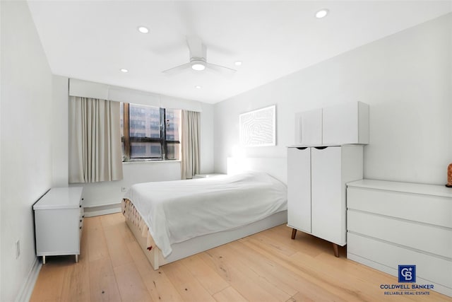 bedroom with ceiling fan and light wood-type flooring