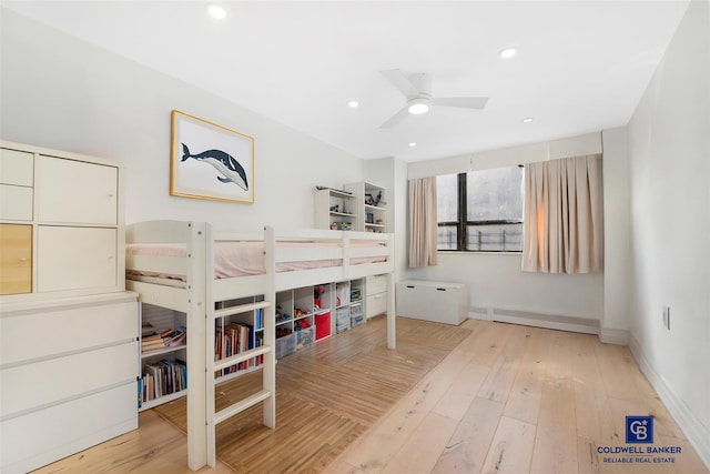 bedroom with wood-type flooring, ceiling fan, and baseboard heating