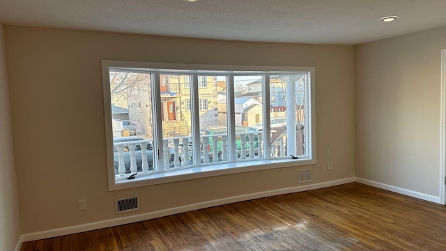 unfurnished room with hardwood / wood-style flooring