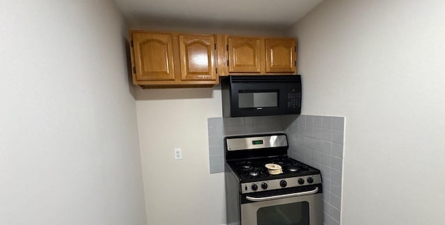 kitchen with tasteful backsplash and gas range